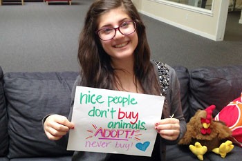 Girl With Nice People Don't Buy Animals Sign
