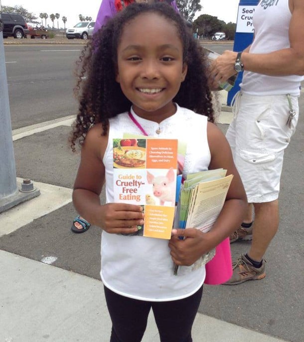 Genesis passing out cruelty-free eating pamphlet.