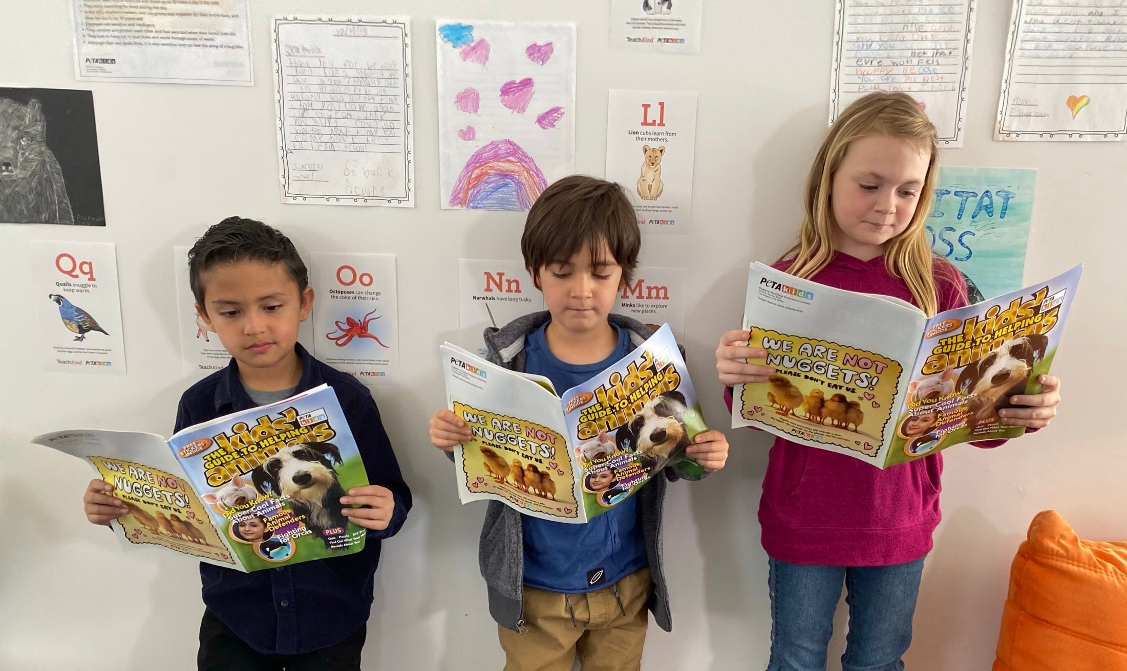 kids reading a kids guide to helping animals