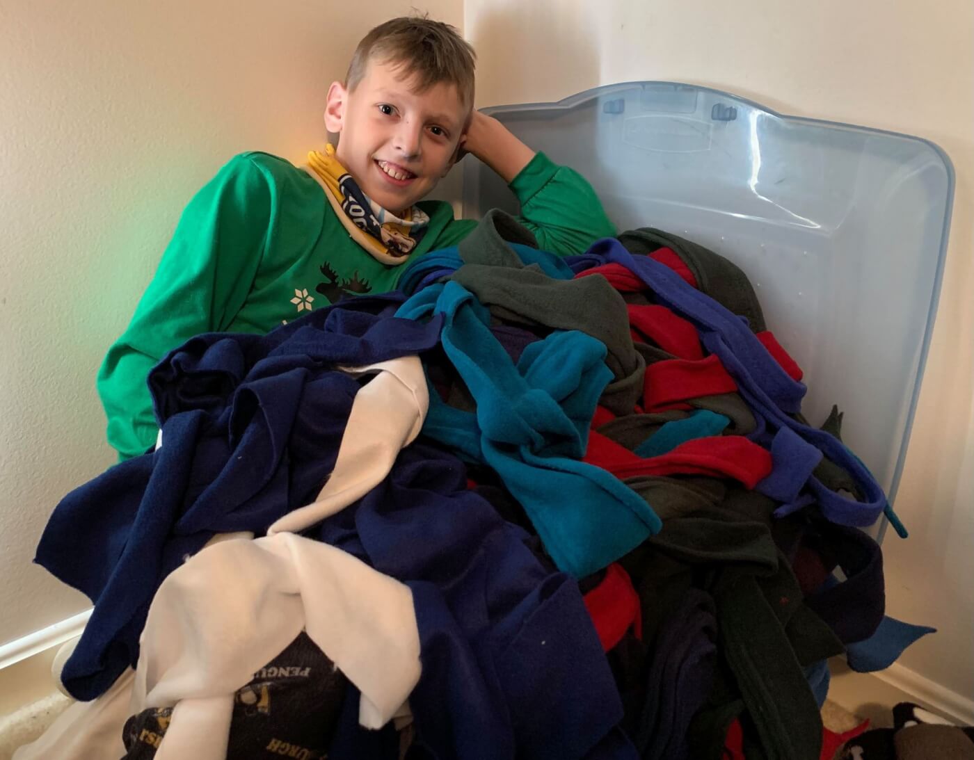 ryan poses next to all of the fleece to make pup tugs