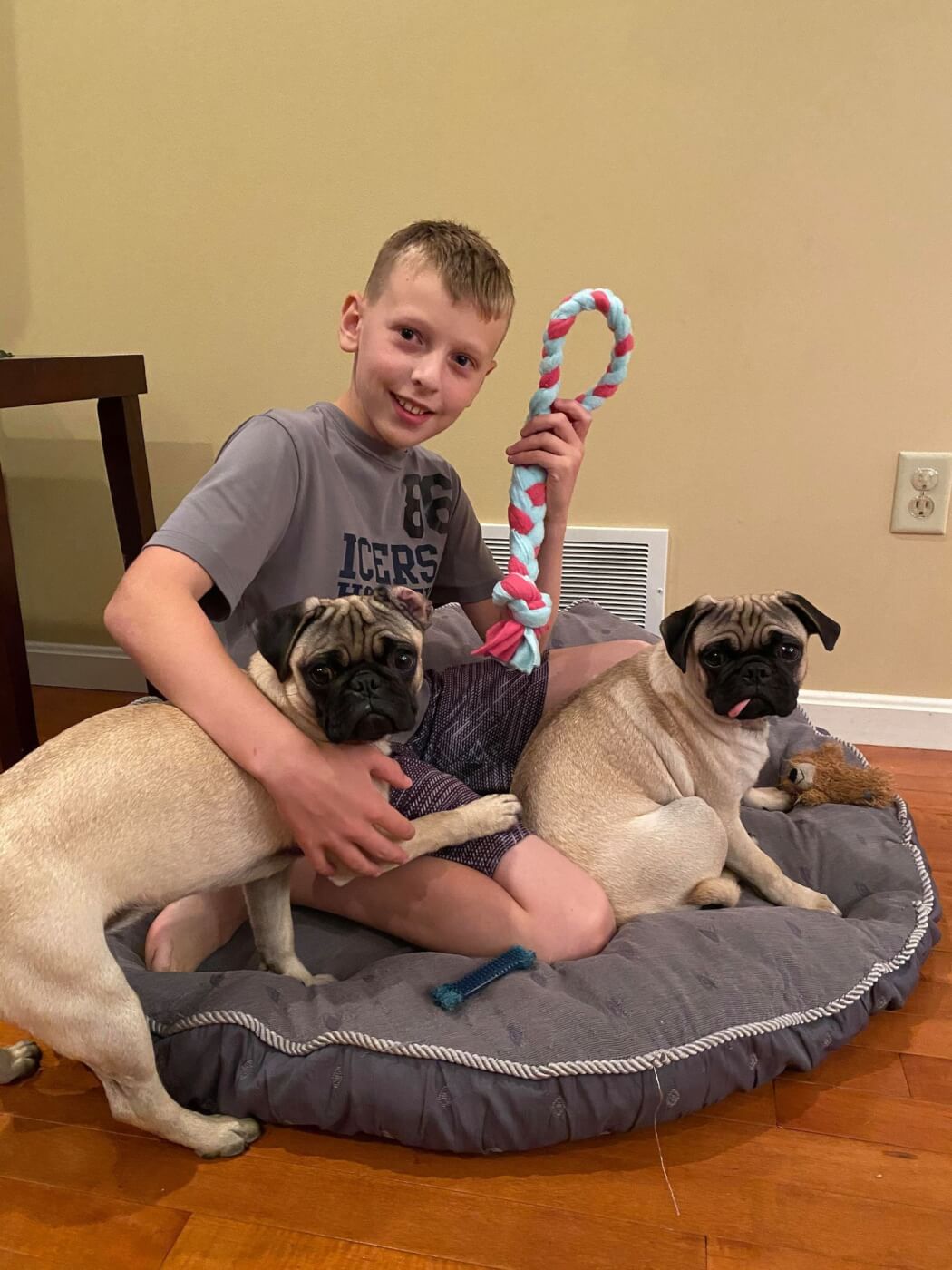 Ryan and his two dogs playing with a pup tug