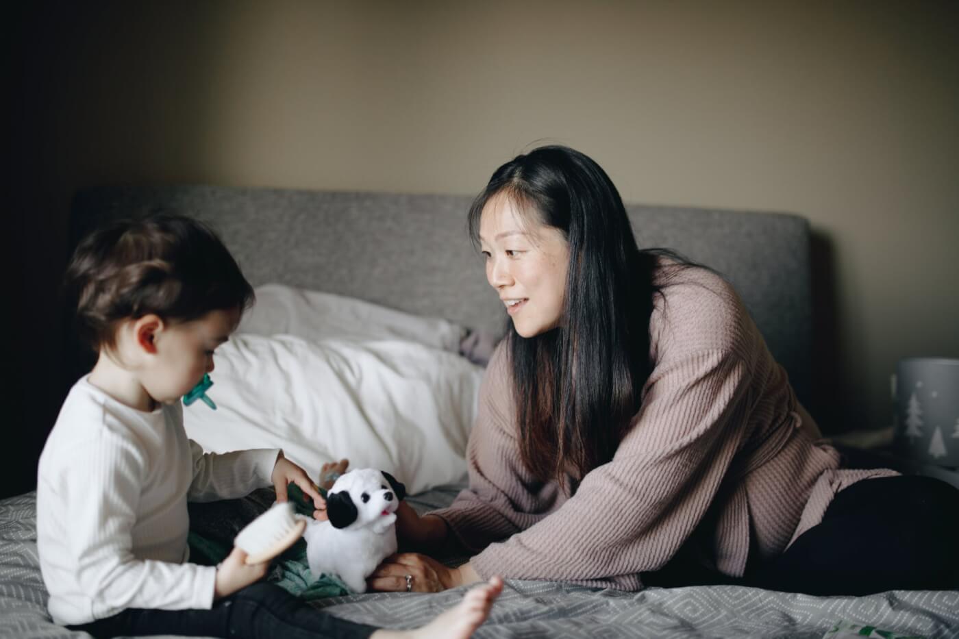 mom with her son playing with stuffed dog