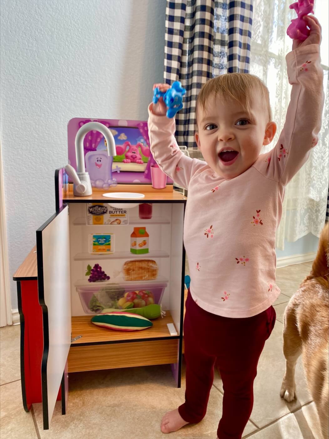 kid playing with toy kitchen