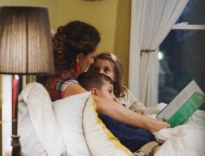mom and kids reading a kids book