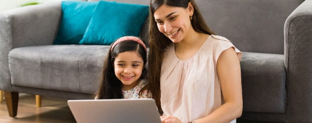 Parent and child looking at laptop