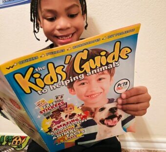 little boy reading a magazine