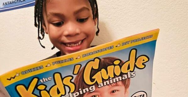 little boy reading a magazine