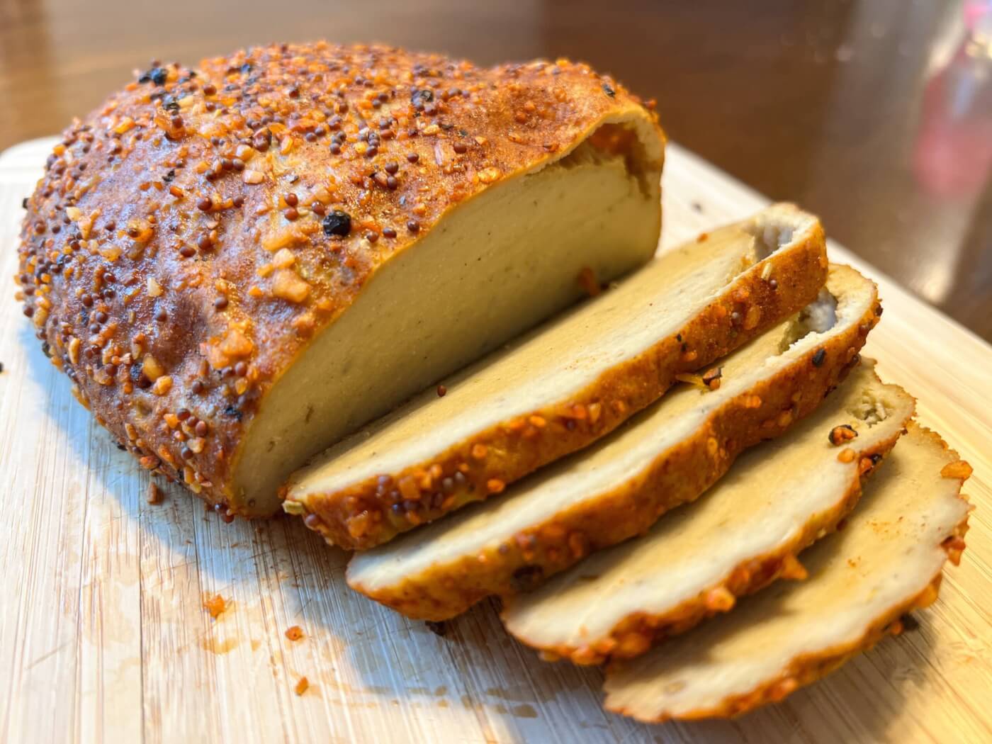 vegan turkey sliced up on a cutting board