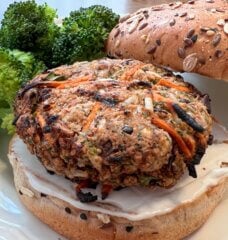 Nora Cooks veggie burger on a bun with a side of broccoli
