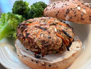 Nora Cooks veggie burger on a bun with a side of broccoli