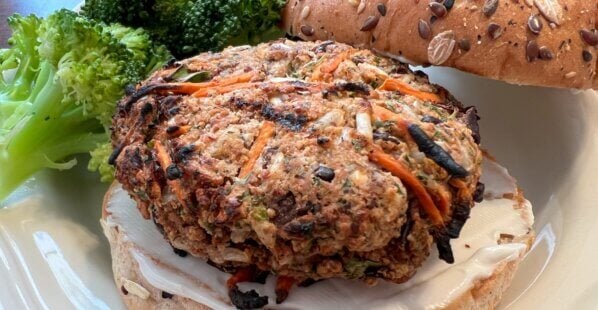 Nora Cooks veggie burger on a bun with a side of broccoli