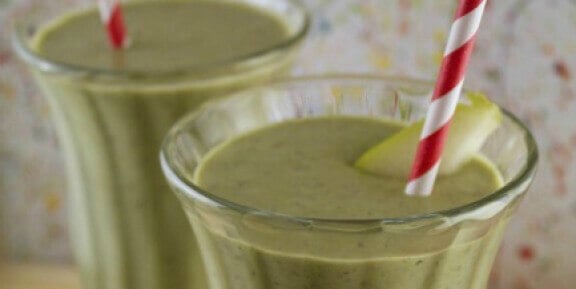 two green kale smoothies with striped red and white straws