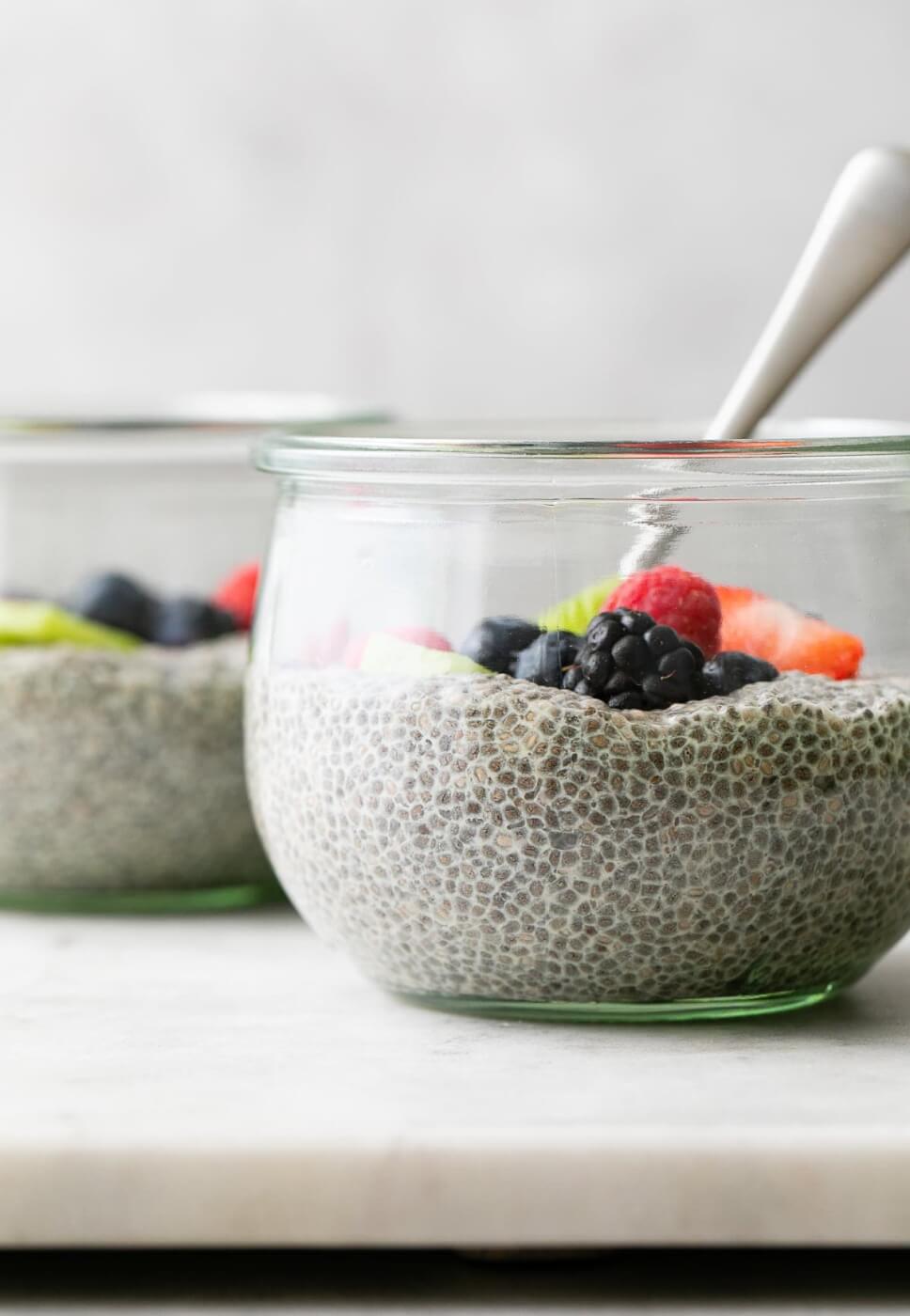 chia pudding in a glass bowl with fruit on top