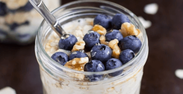 overnight oats in a mason jar with granola and blueberries