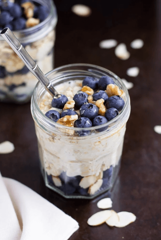 overnight oats in a mason jar with granola and blueberries