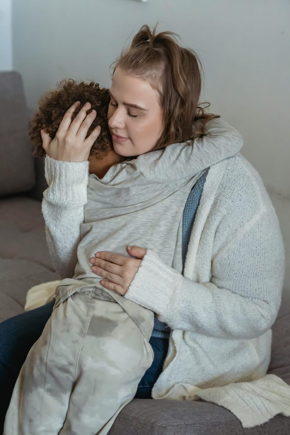 mom is holding her small child to comfort him.