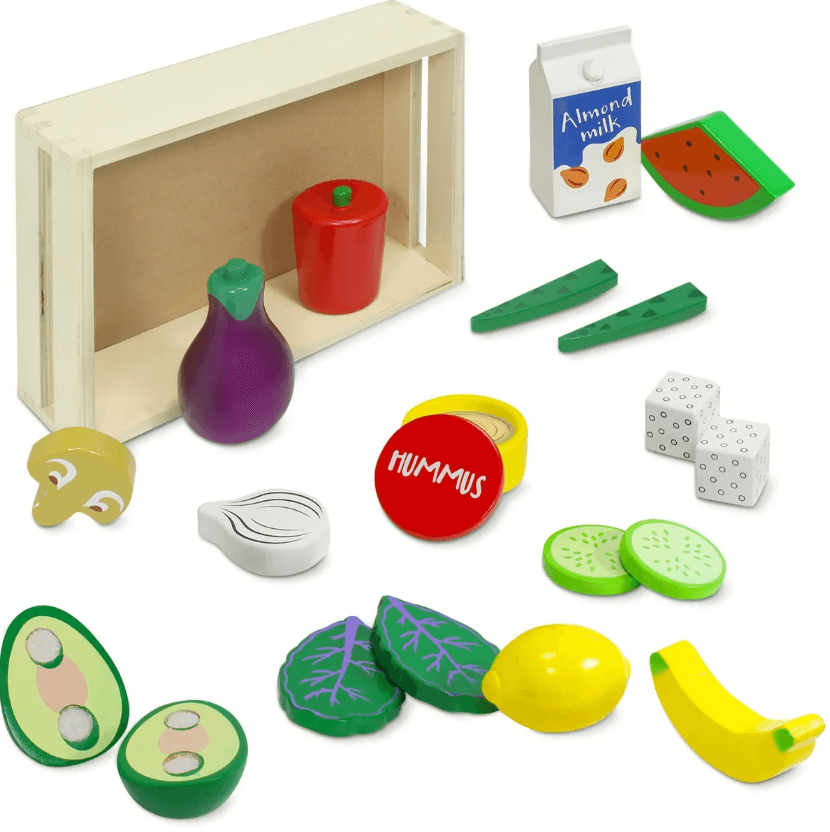 an array of food--like bananas, cucumbers, avocado, hummus, tofu, and more--sprawled on the floor with a food box next to it.
