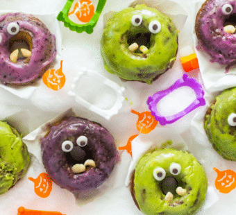 purple and green monster donuts surrounded by monster fangs
