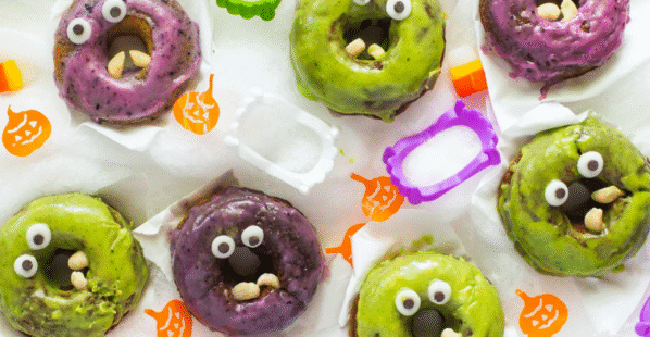 purple and green monster donuts surrounded by monster fangs
