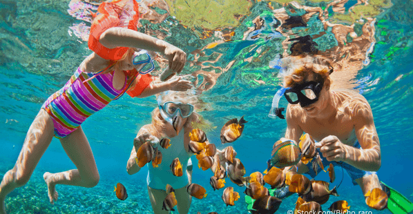 family_snorkeling_underwater_looking_at-fish_two_children_one_man